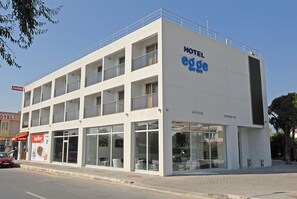 A modern hotel building with a prominent 'HOTEL egge' sign, multiple balconies, and large windows. - Hotel Egge (Cesme)
