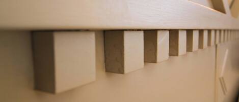A close-up of a white wooden wall with evenly spaced vertical indentations.