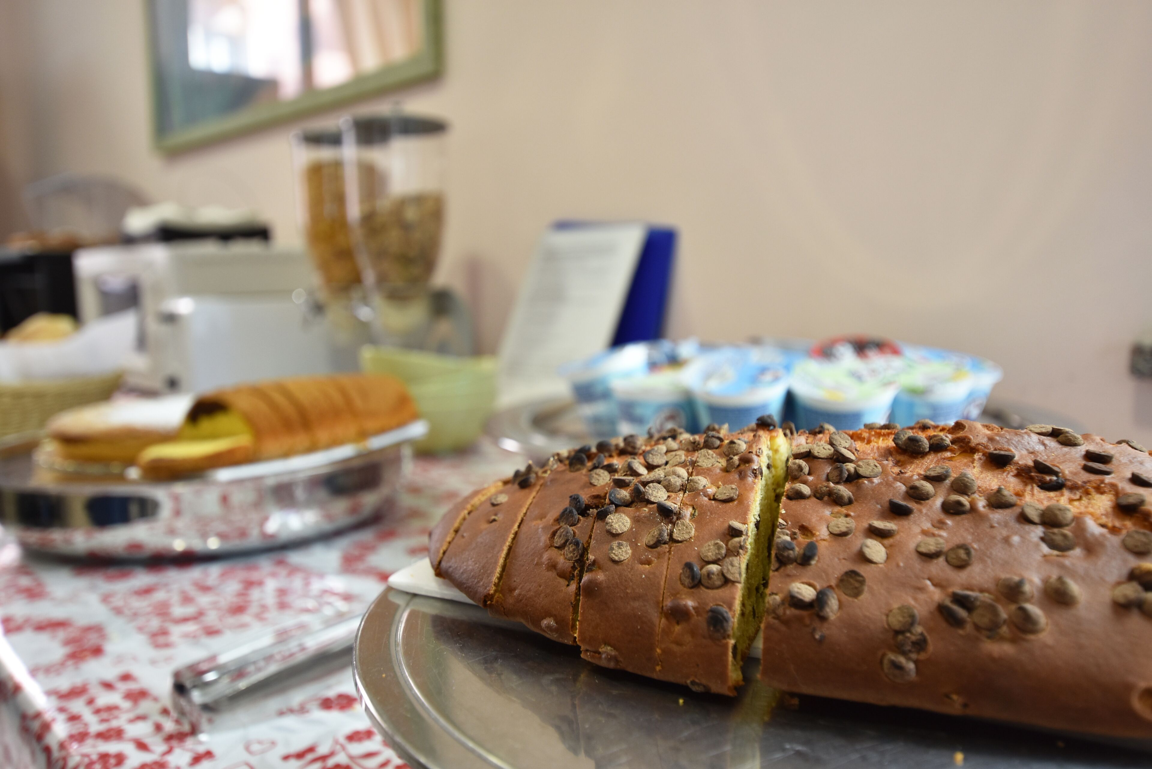 A loaf of bread with seeds on a metal tray.