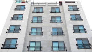 A multi-story hotel with a modern facade, featuring a prominent 'SB HOUSE' sign at the ground level. - SB Guest House (Suwon)