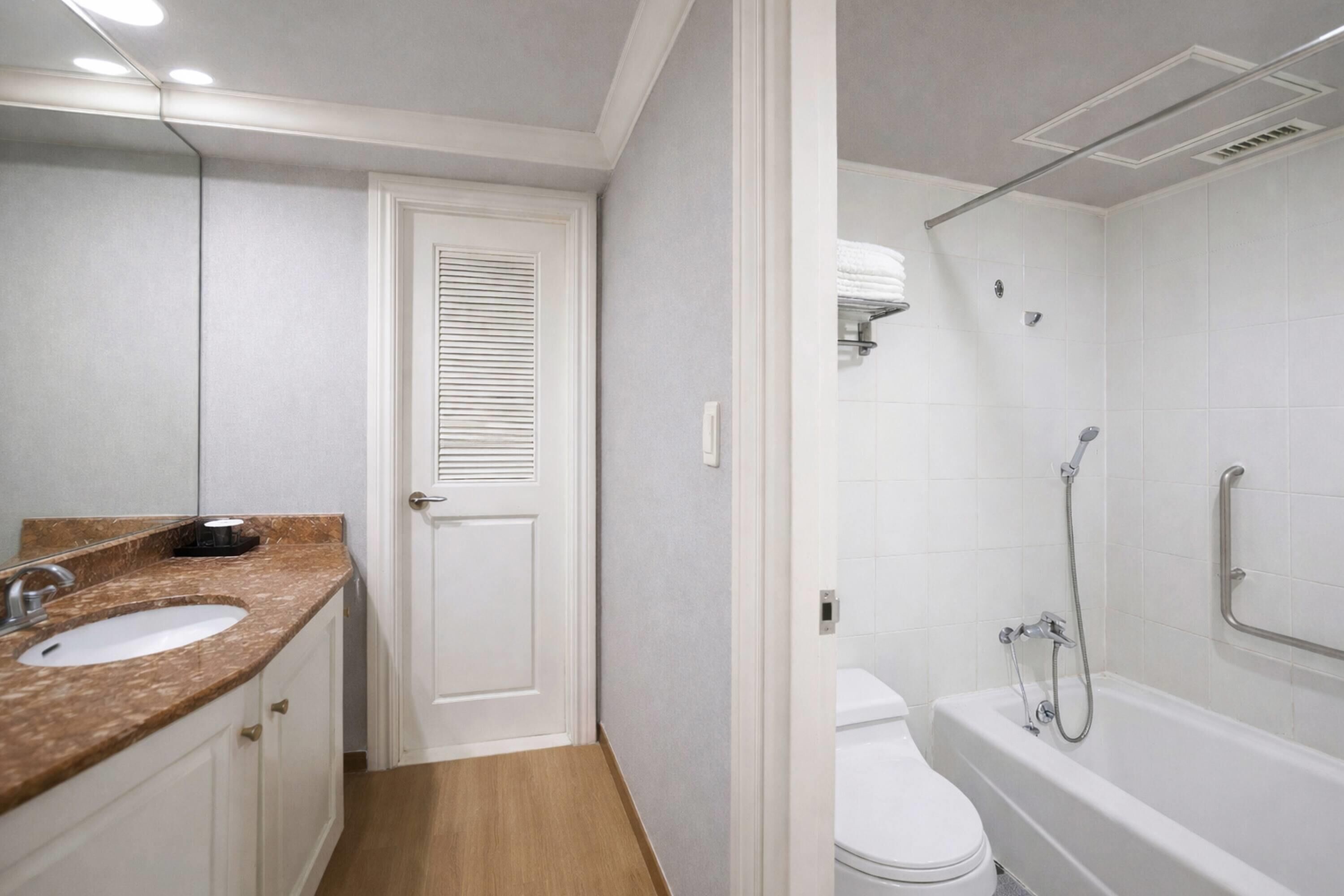 A bathroom with a sink, toilet, and bathtub.
