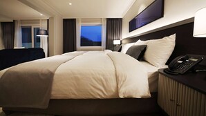 A hotel room with a large bed, bedside tables, a flat-screen TV, and a window with curtains. - La Vie Dor Hotel and Resort, Trademark Collection by Wyndham (Hwaseong)