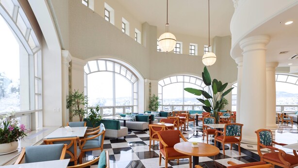 A spacious hotel lobby with high ceilings, large windows, and a checkered floor. - La Vie Dor Hotel and Resort, Trademark Collection by Wyndham (Hwaseong)