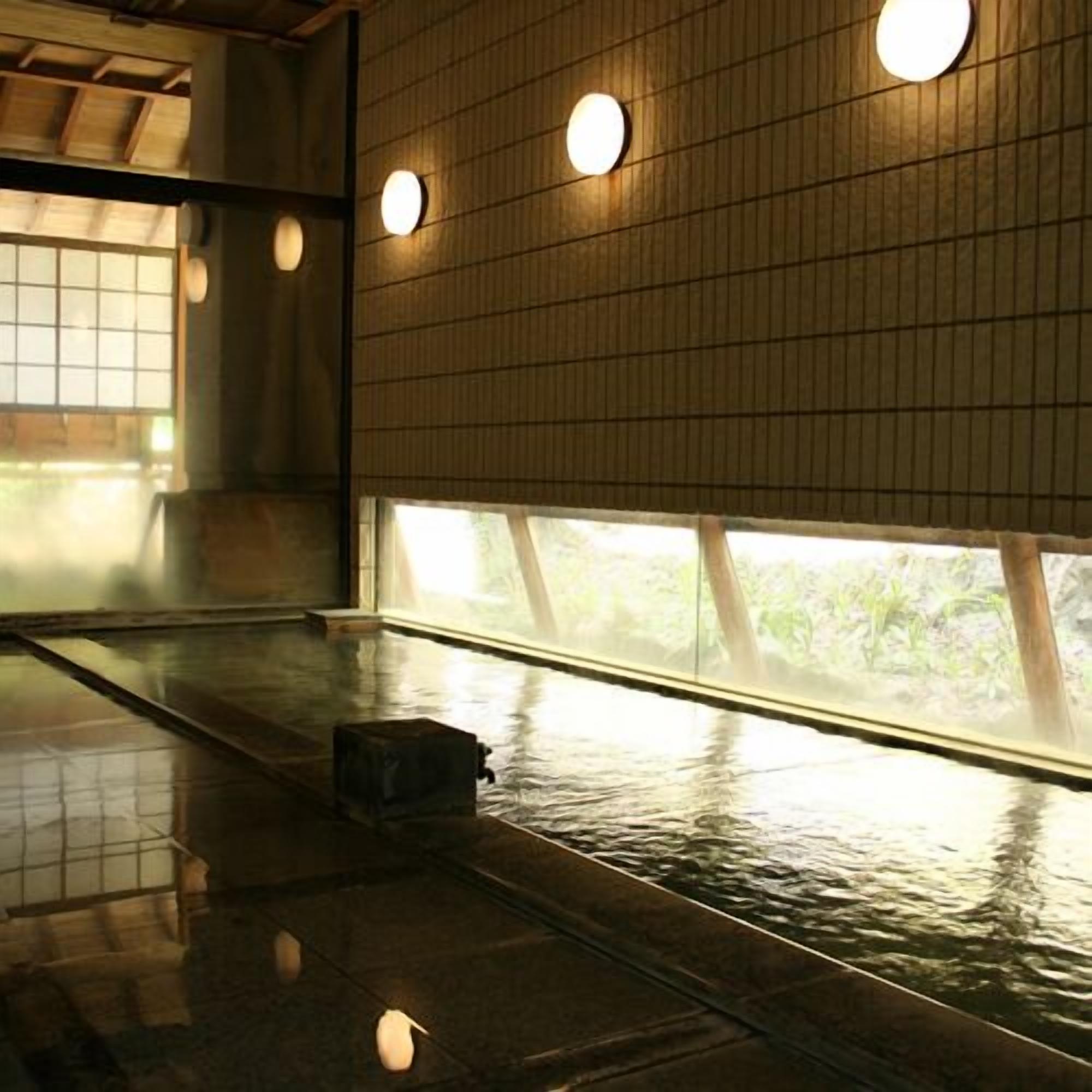 A room with tatami mats, a wooden floor, a window with a view of greenery, and a traditional Japanese lantern.