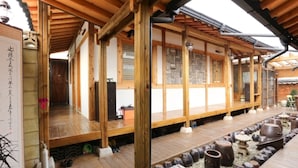 A traditional Japanese-style building with wooden beams and tatami mat flooring.