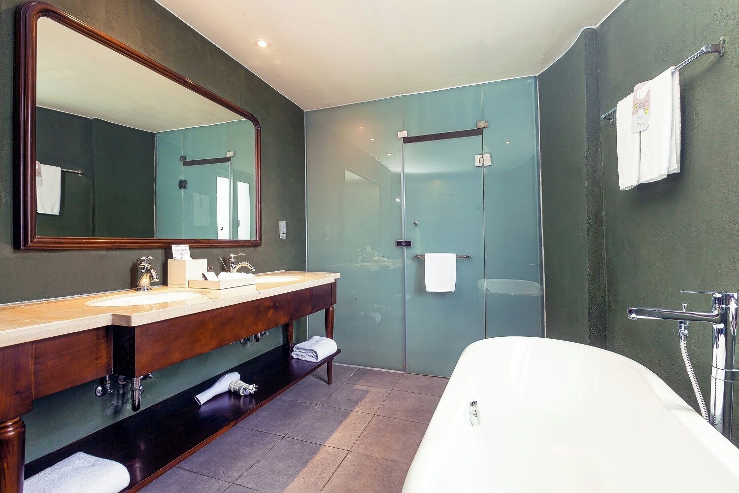 designer toiletries, hair dryer, slippers, towels