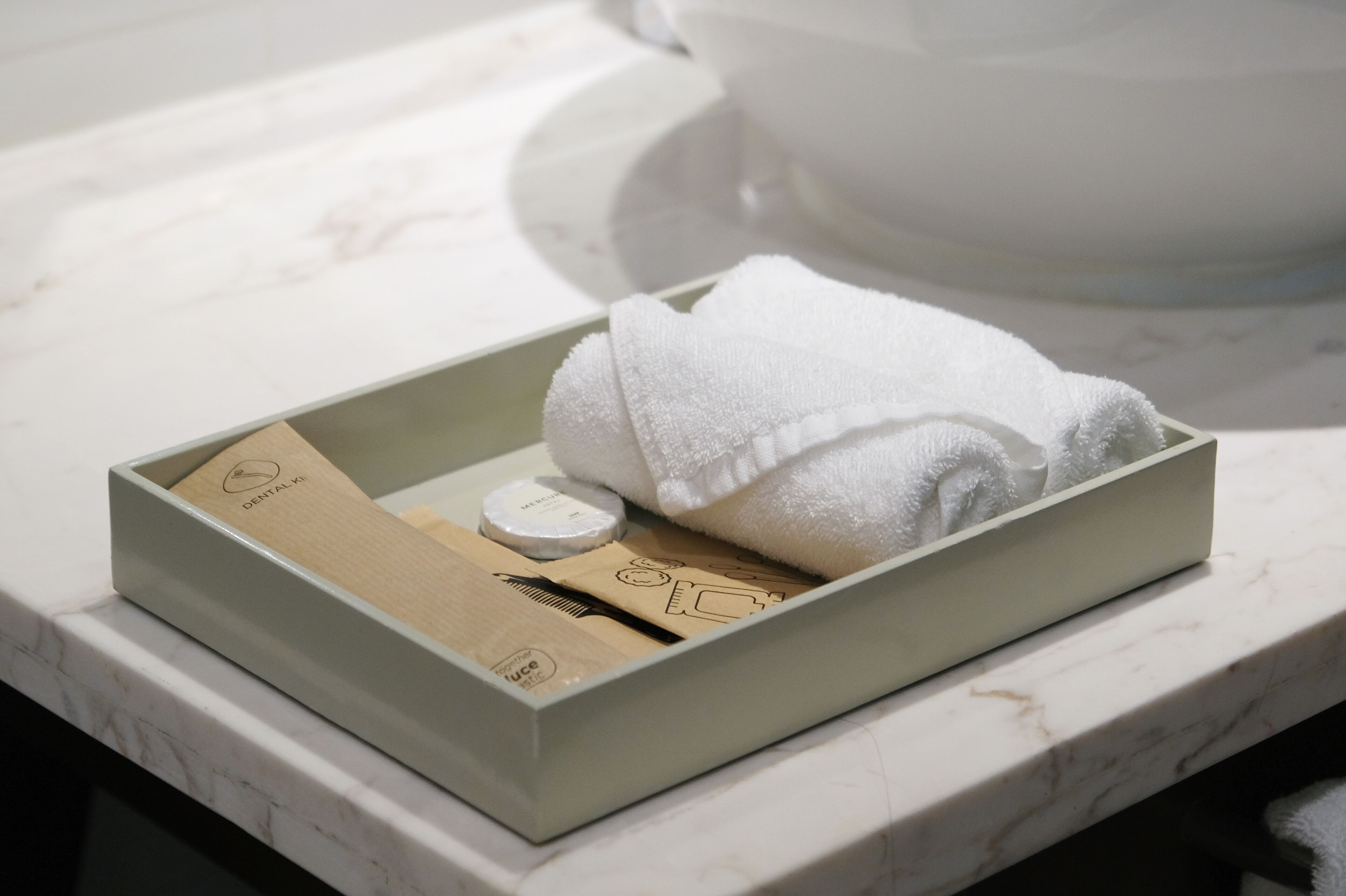 designer toiletries, hair dryer, slippers, towels