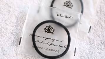 Two hair rings in clear plastic packaging with text.