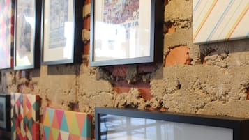 A wall with framed pictures and a black and white photograph.
