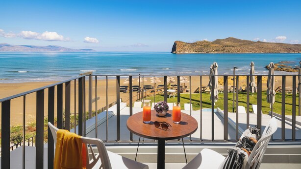 A balcony with a table, two drinks, and a pair of sunglasses. - Elia Agia Marina Hotel (Chania)