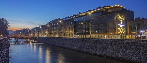 A modern building with a glass facade and a sign reading "President."