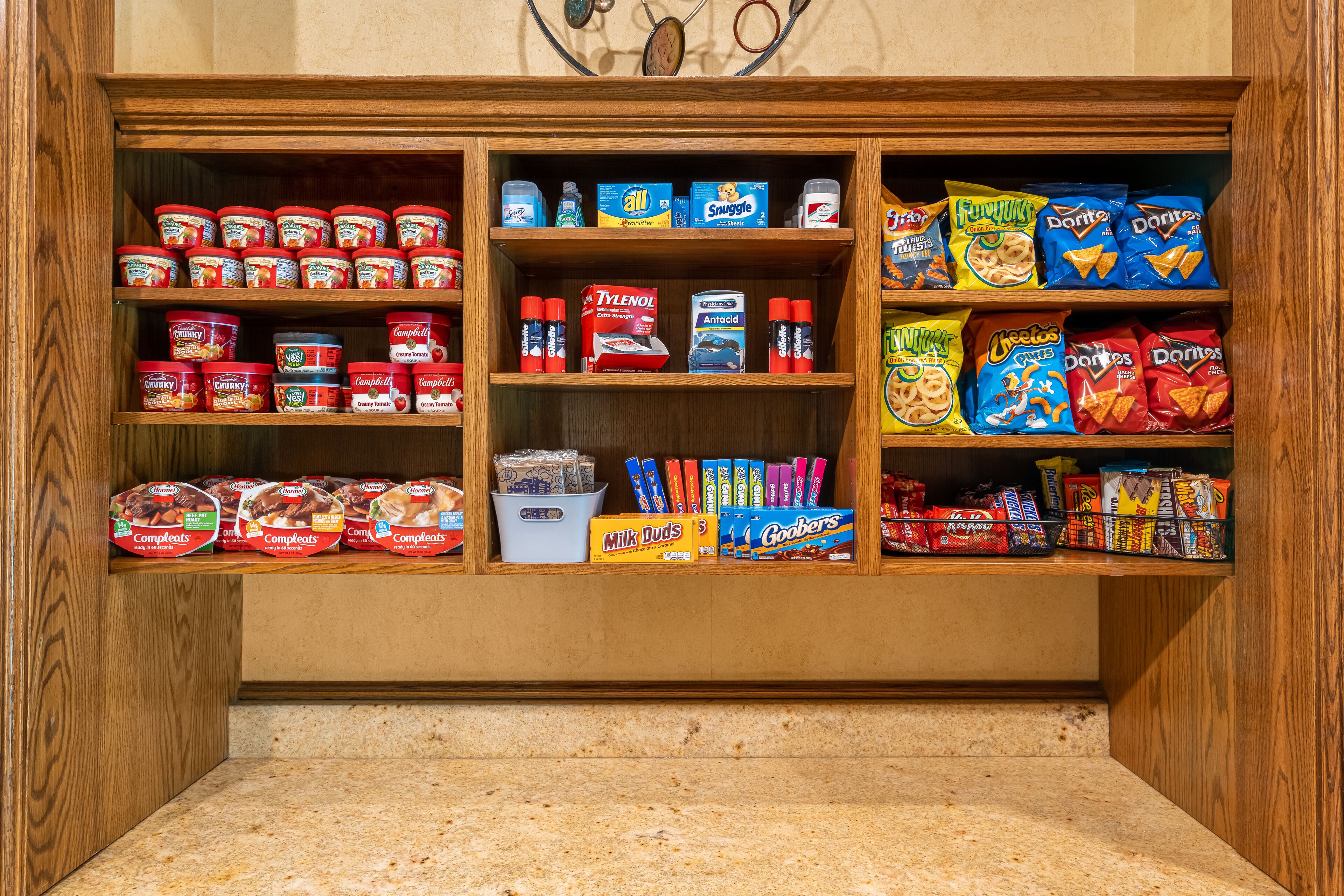 A pantry stocked with various food items including canned goods, snacks, and condiments.
