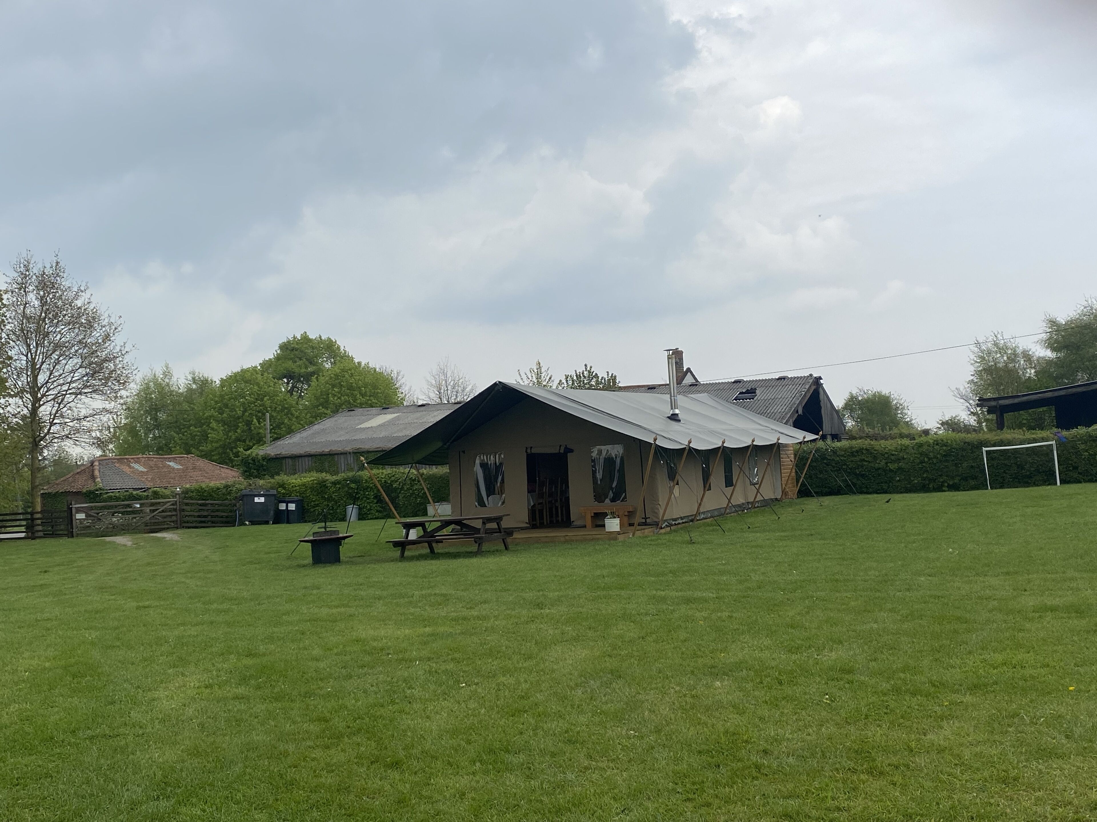 A rustic house with a sloped roof, a chimney, and a small porch area.