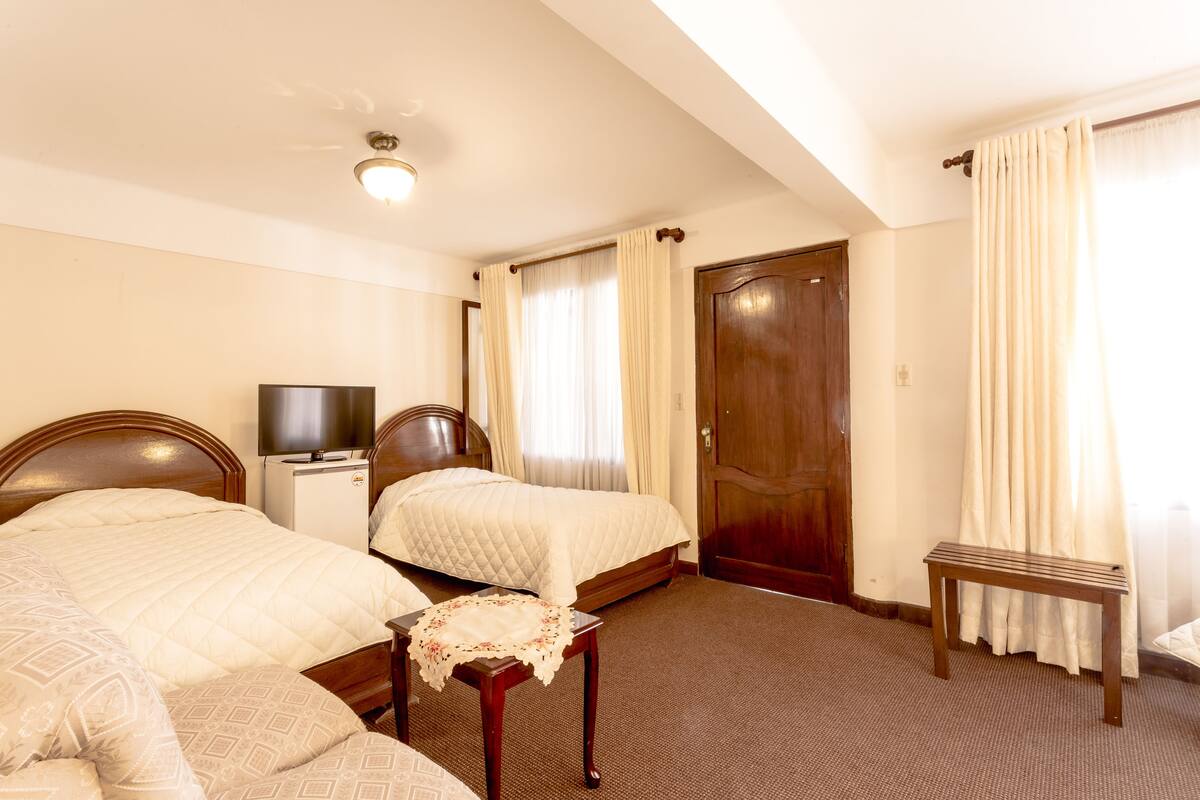 Triple Room | Minibar, in-room safe, individually decorated, desk