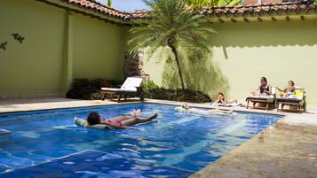 Outdoor pool, open 7 AM to 11 PM, pool loungers