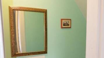 A bathroom with a sink, mirror, and toilet.