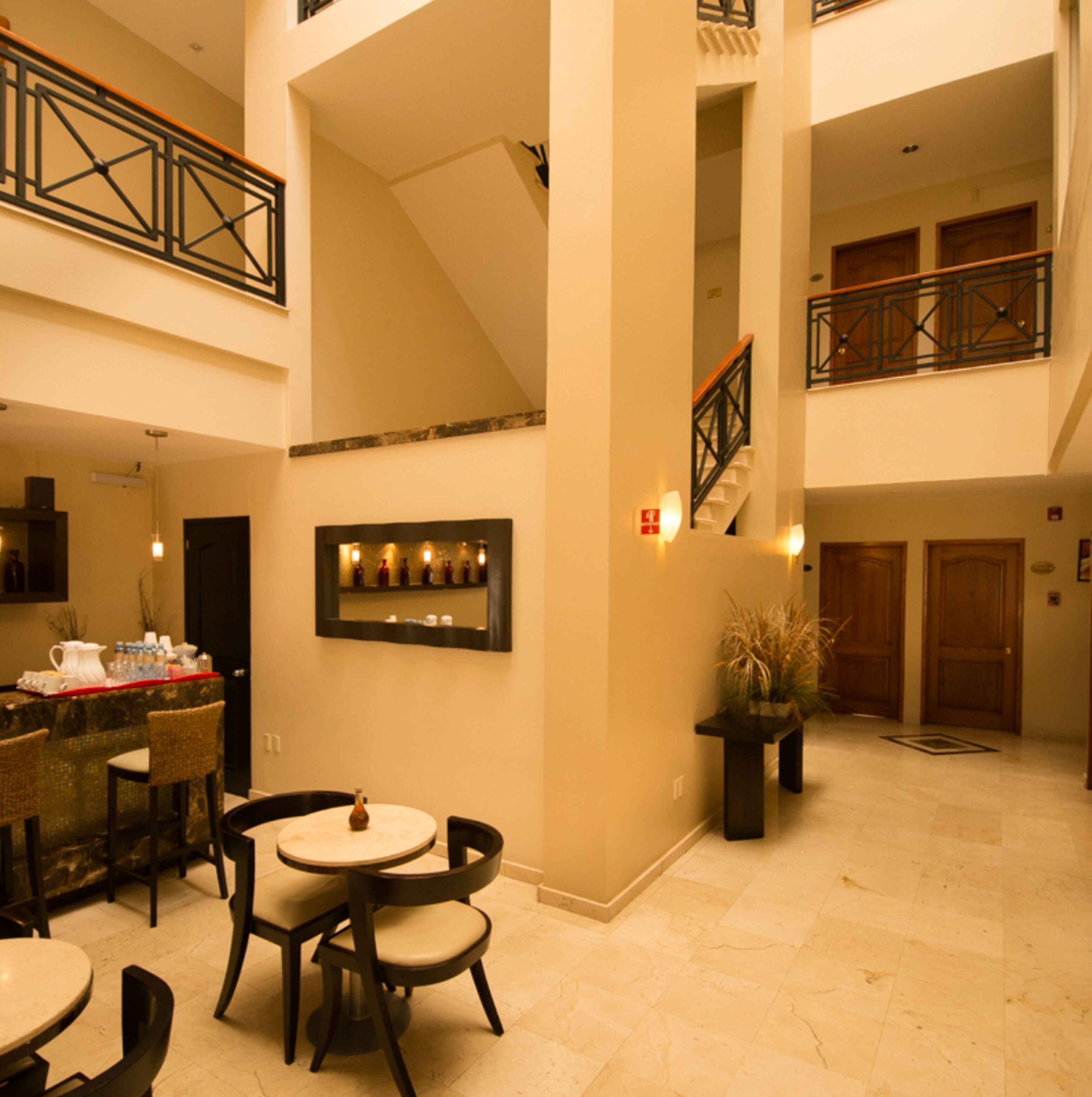 A spacious interior with a dining area, a staircase, and a balcony.