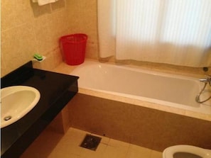 A bathroom with a bathtub, toilet, and sink. - Nha Khach Tien Giang (My Tho)