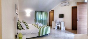 Deluxe Triple Room, Partial Sea View | Premium bedding, minibar, in-room safe, individually decorated