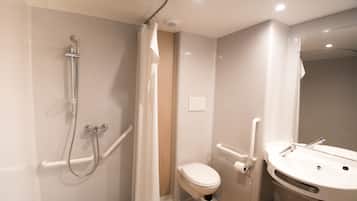 A modern bathroom with a shower, toilet, and sink.
