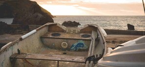 A boat with a worn-out interior, a metal hatch, and a metal handle. - Hope & Anchor (Kingsbridge)