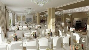 A spacious banquet hall with white tables and chairs, chandeliers, and large windows. - Hotel Gala (Cluj-Napoca)