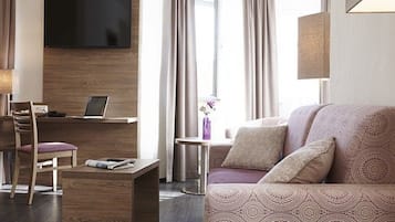 Suite Deluxe, 1 habitación, vistas a la ciudad | Zona de estar | Una televisión de pantalla plana