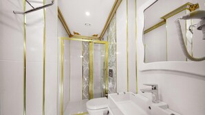 A modern bathroom with a glass-enclosed shower, a white toilet, and a large sink with a mirror above it. - Babel Park Hotel (Istanbul)