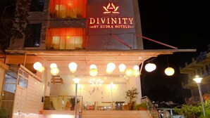 A hotel entrance with a sign reading "DIVINITY BY AURA HOTELS". - Divinity By Audra Hotels (Mathura)