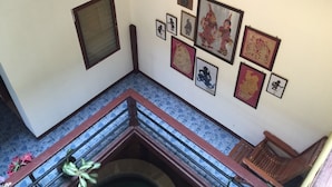 A staircase with a handrail and a tiled floor.