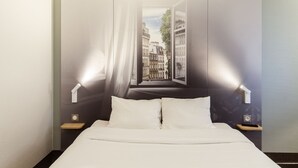 A hotel room with a large bed, two bedside tables, and a view of a cityscape through an open window. - B&B Hôtel La Queue En Brie (La Queue-en-Brie)