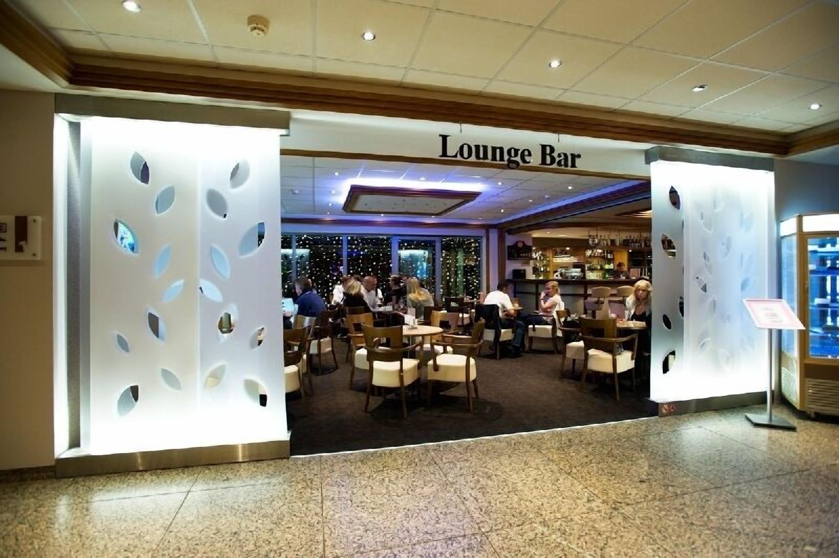 Un bar-lounge de diseño moderno, con zona de bar y asientos para los huéspedes.