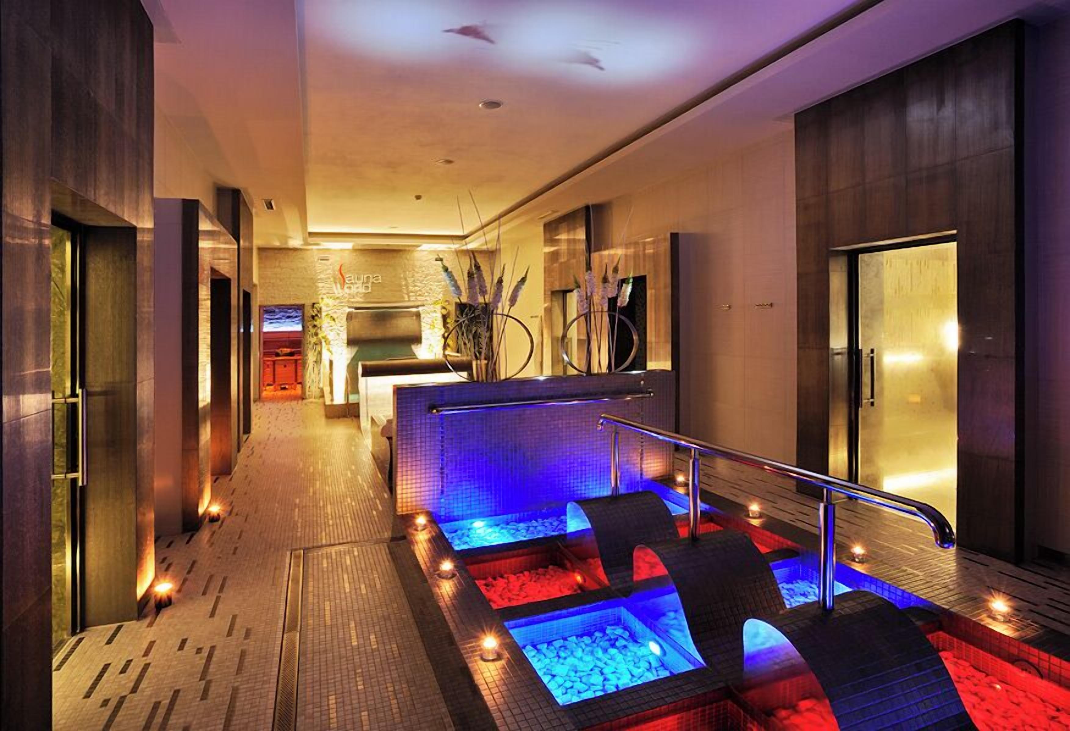 A modern spa area with heated pools and a reception desk.