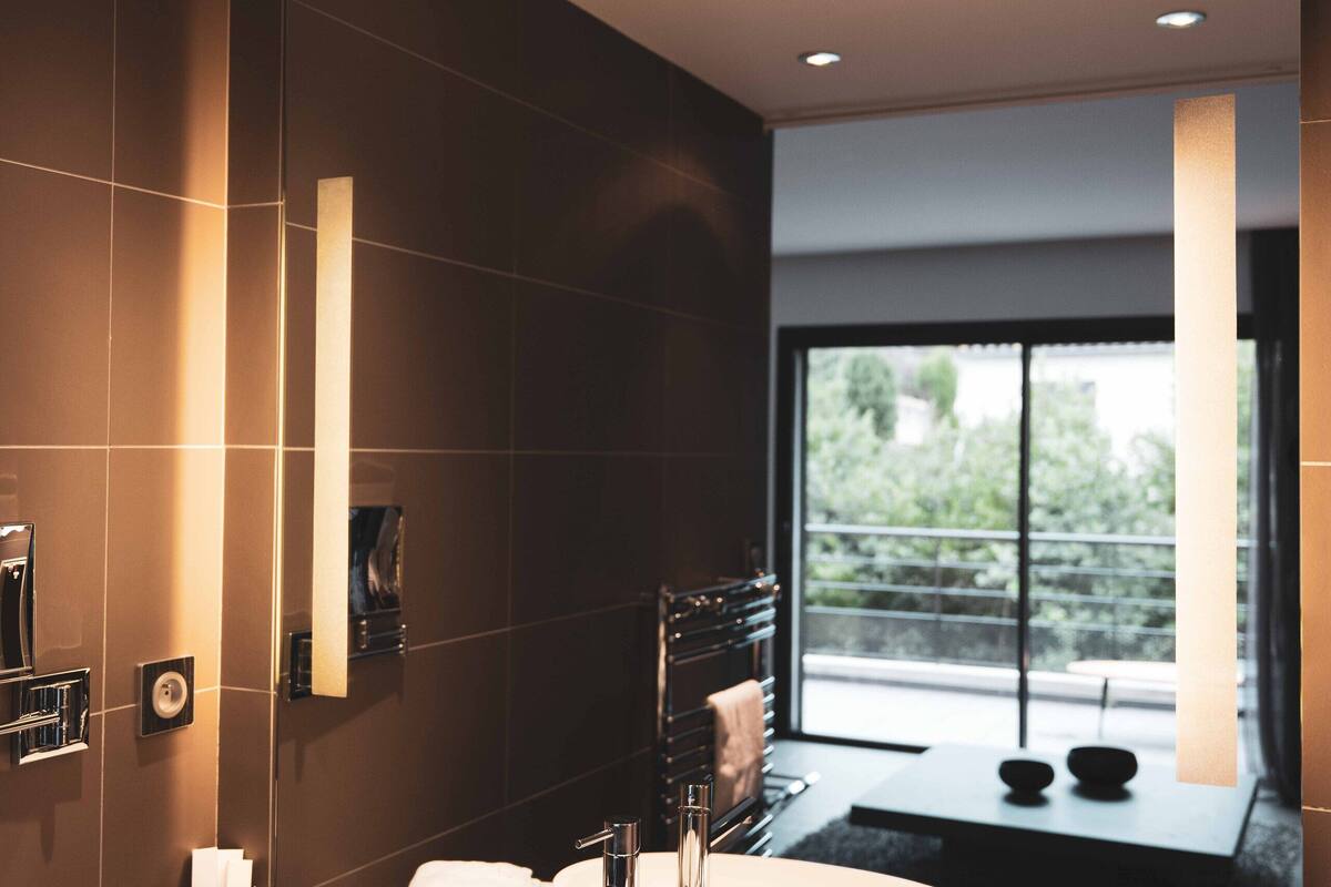 junior suite | bathroom | shower, free toiletries, hair dryer, dressing gowns