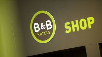 A B&B Hotels sign with the word "SHOP" next to it.
