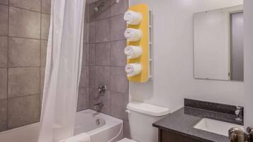 Separate bathtub and shower, towels