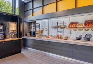 A breakfast buffet with various food items and a coffee machine. - B&B HOTEL Bordeaux Centre Bègles (Begles)
