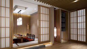 A traditional Japanese-style room with tatami flooring, a low table with cushions, and sliding doors with a grid pattern. - Sheraton Shanghai Jiading Hotel (Shanghai)