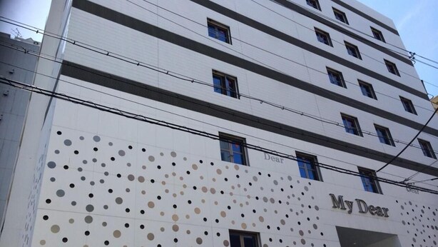 A multi-story building with a white facade and a pattern of dots. The name "My Dear" is visible on the building. - My Dear - Adults Only (Osaka)