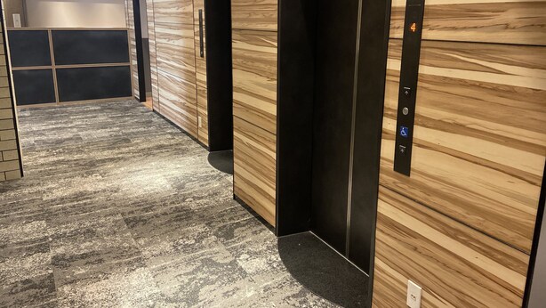A modern elevator with a control panel and a wooden wall. - My Dear II - Adults Only (Osaka)