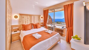 A hotel room with a bed, a nightstand, a bathroom, and a view of the sea. - Hotel Aysima (Kas)