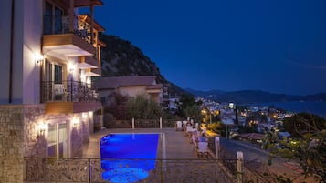 Outdoor pool, a waterfall pool, open 11:00 AM to 7:30 PM, pool loungers