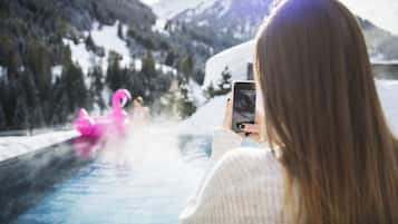 Guests can enjoy the serene poolside views of the surrounding mountains and trees.