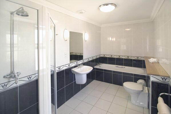 Separate bathtub and shower, free toiletries, hair dryer, towels