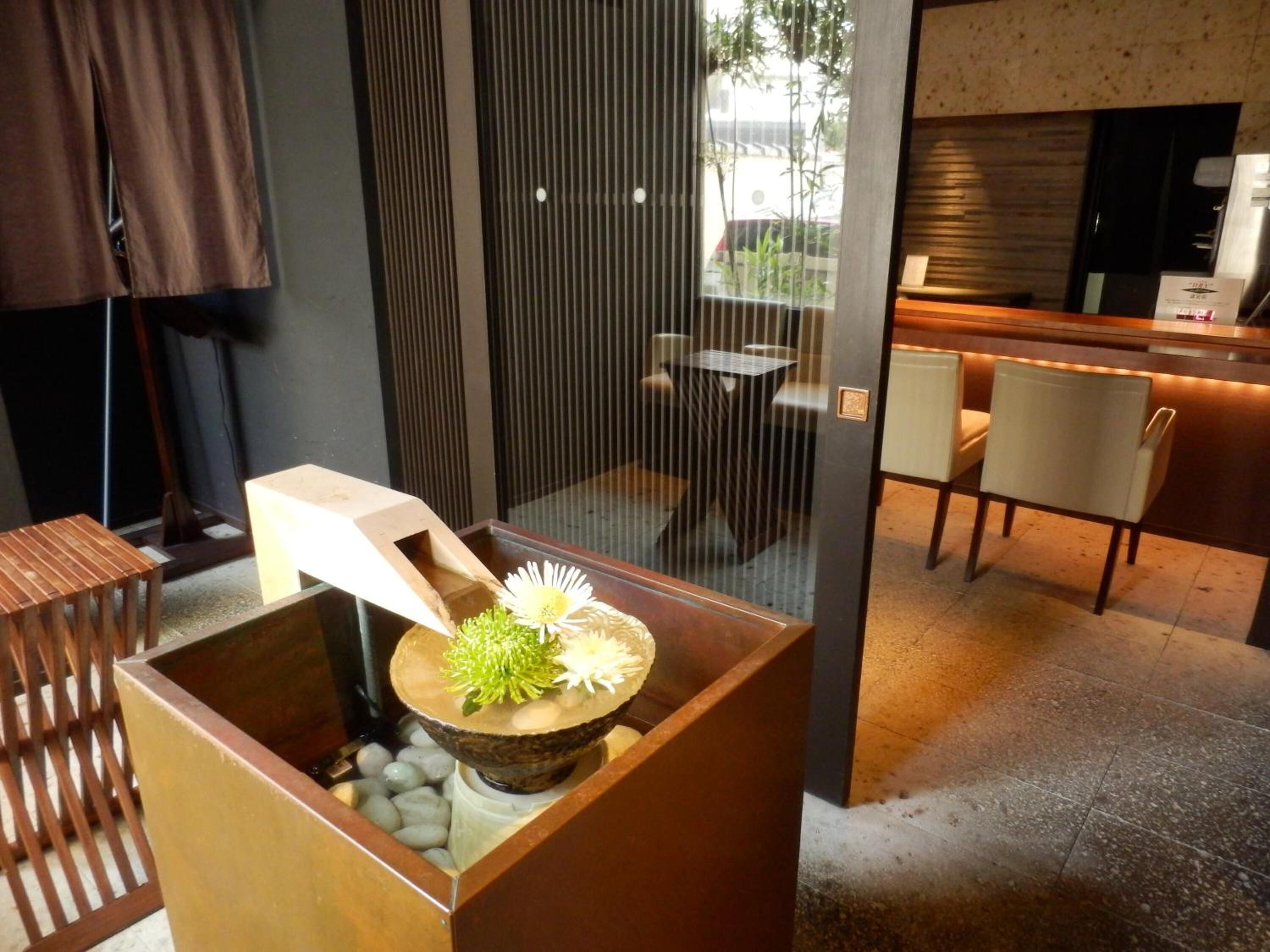 A modern interior with a seating area, a decorative centerpiece, and a view of the outside.