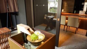 A modern interior with a seating area, a decorative centerpiece, and a view of the outside.