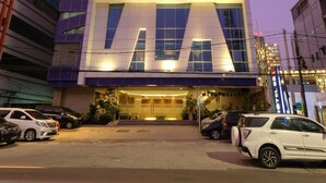A modern hotel with a prominent 'HOTEL 88' sign, featuring a sleek, multi-story design with large windows and a well-lit entrance. - Hotel 88 Mangga Besar 62 by WH (Jakarta)