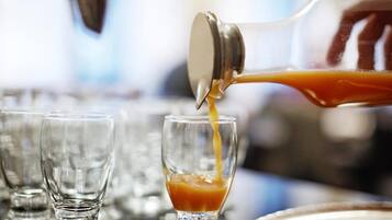 A cocktail being poured into a glass.