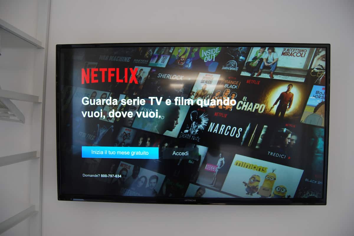 A wall-mounted display advertising Netflix with various TV show and movie thumbnails.