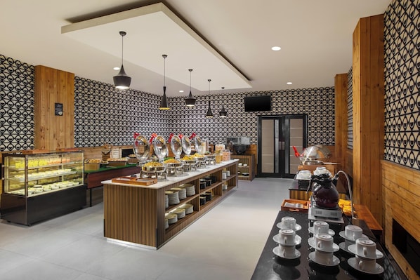 A buffet setup with various food items and a coffee station. - Hotel NEO Dipatiukur - Bandung by ASTON (Bandung)